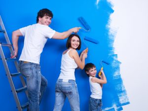 Family painting a wall DIY
